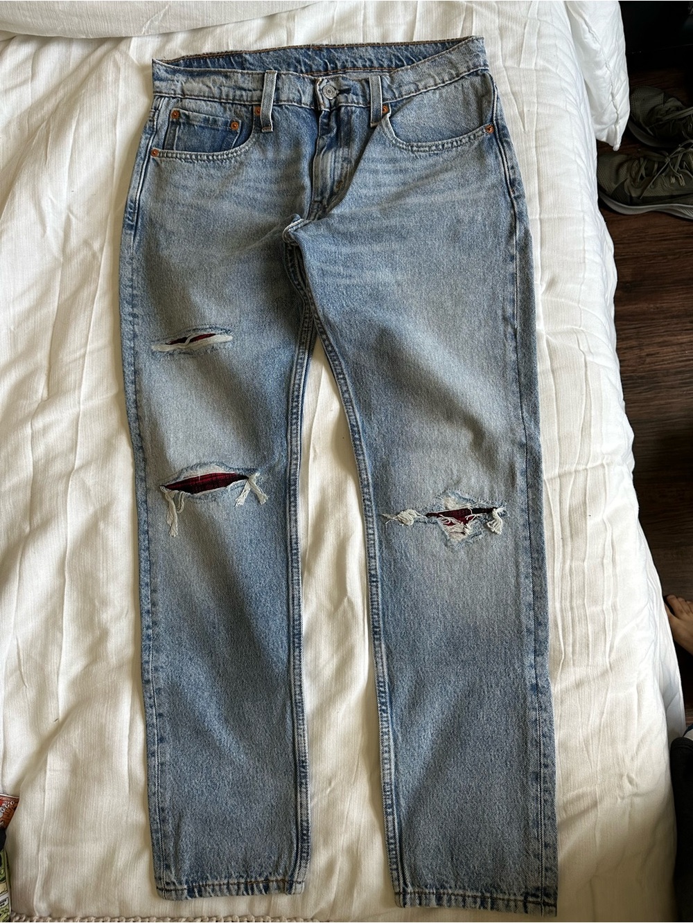 Levi’s 512 slim taper jeans with red plaid detail under rips. 31x30